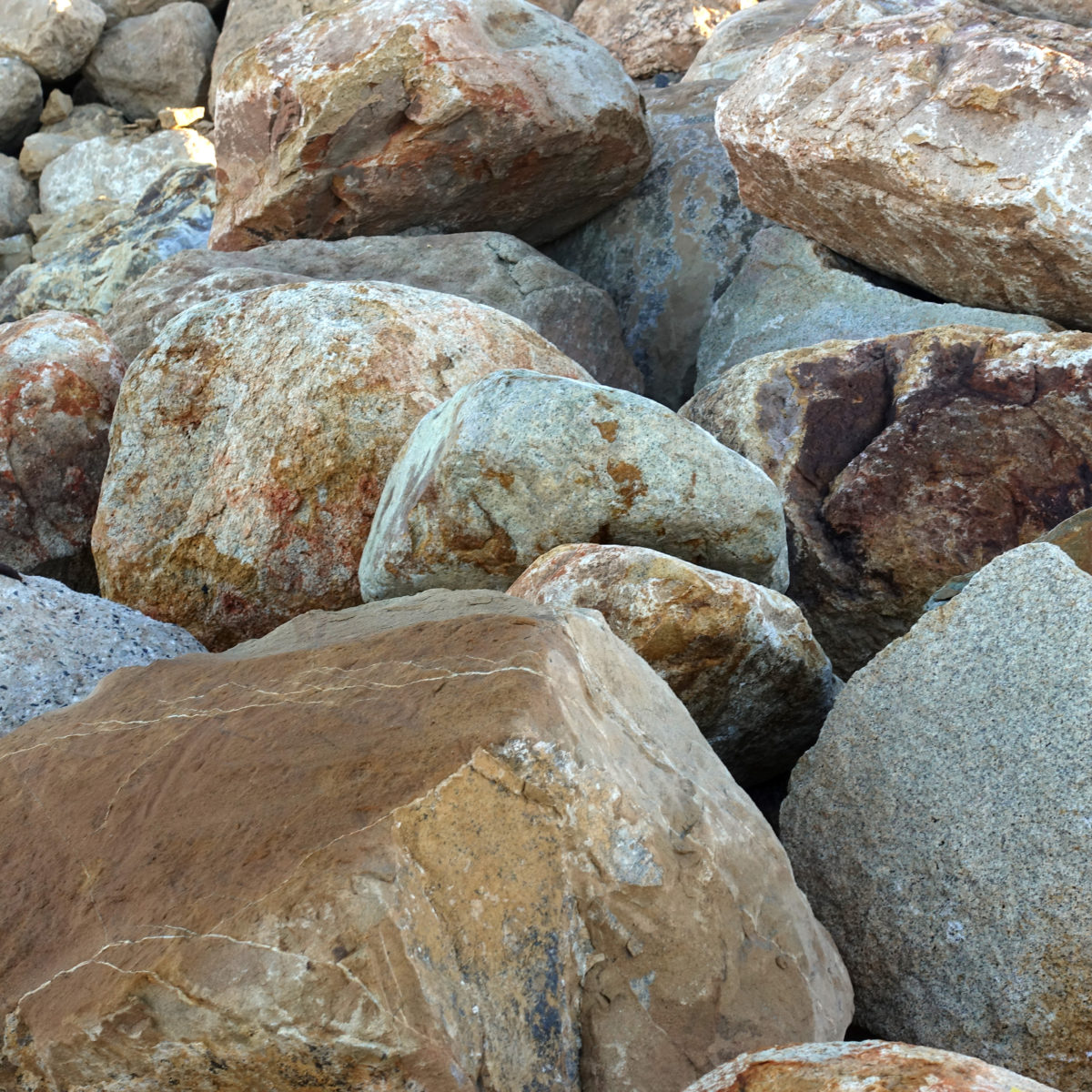 Group of brown ale landscape boulders in rock yard