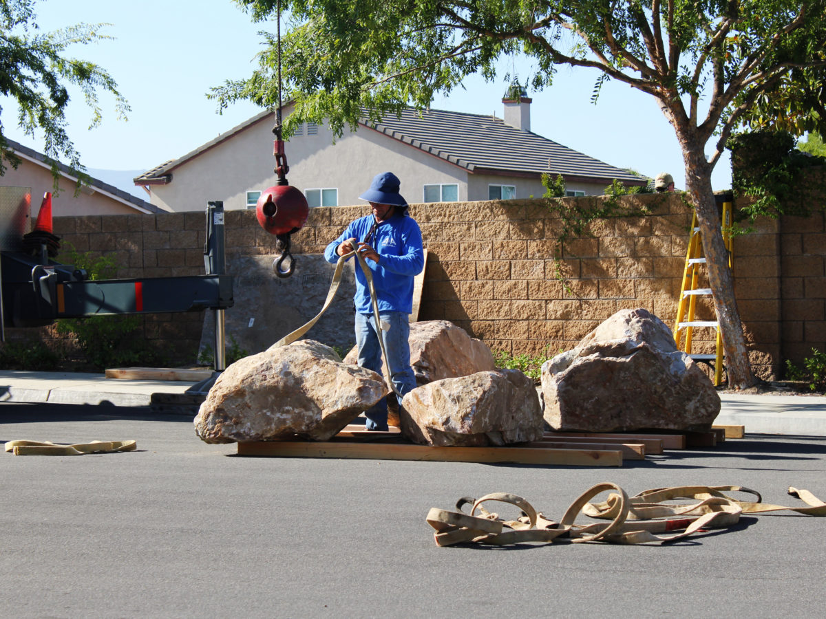 harnessing boulder for placement in yard