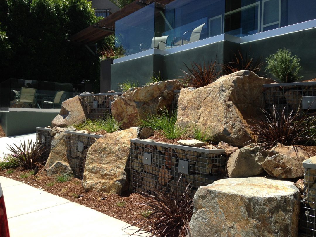 Large boulders next to pathway in yard