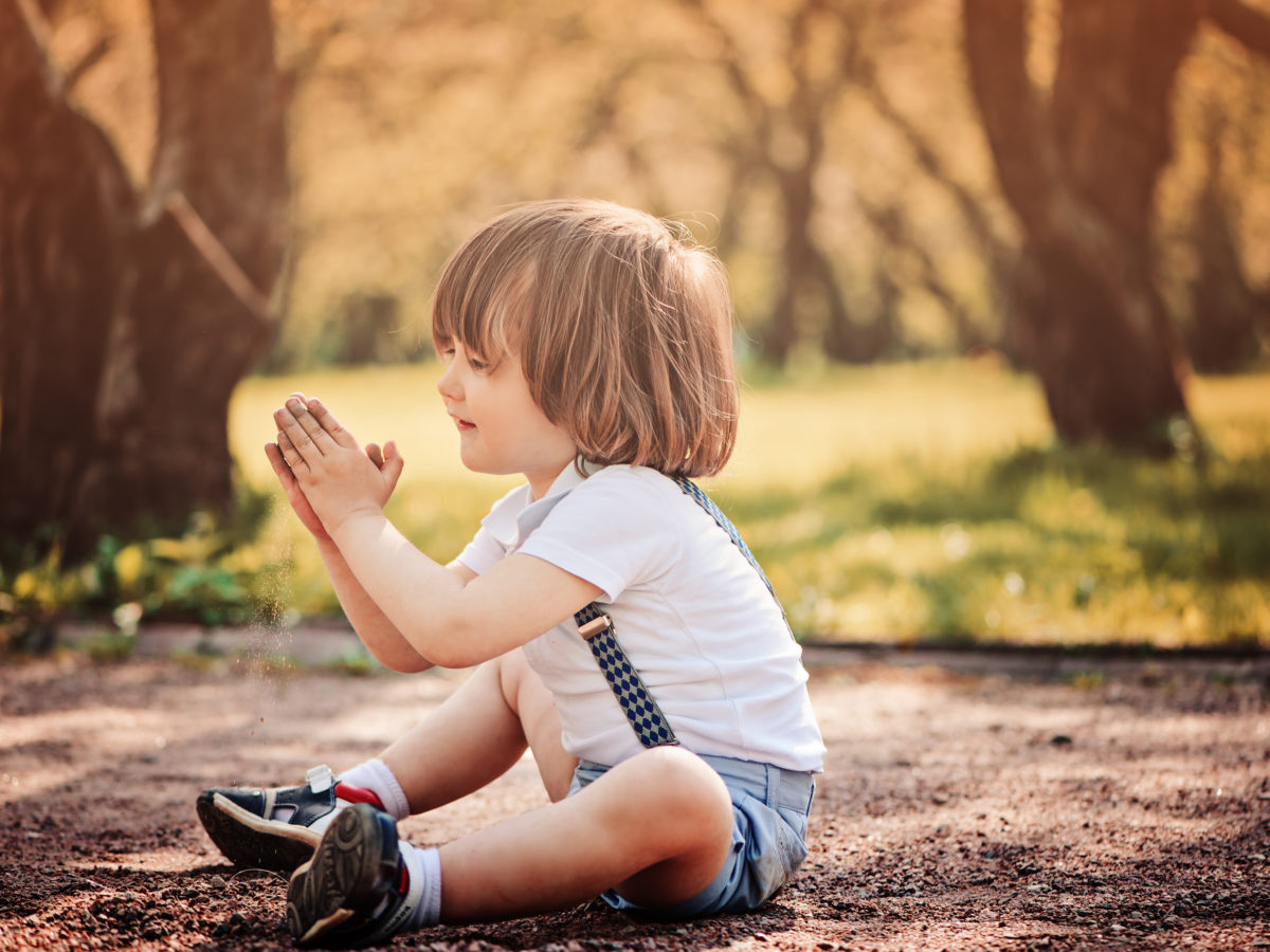 Child sitting on decomposed granite pathway landscape rock projects
