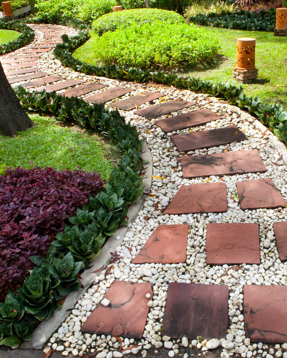 Stepping stone landscape rock project with pebbles in backyard