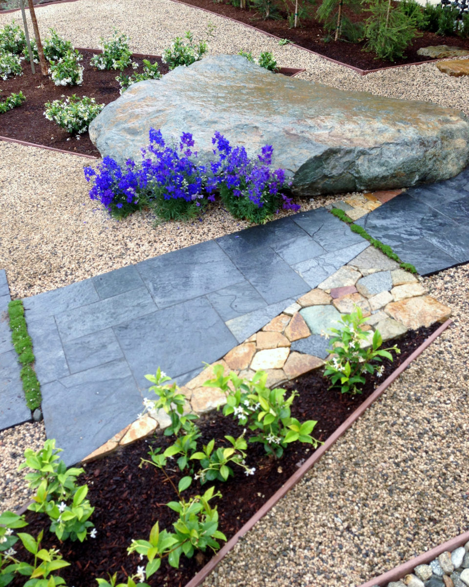 Zen garden flagstone pathway with boulder