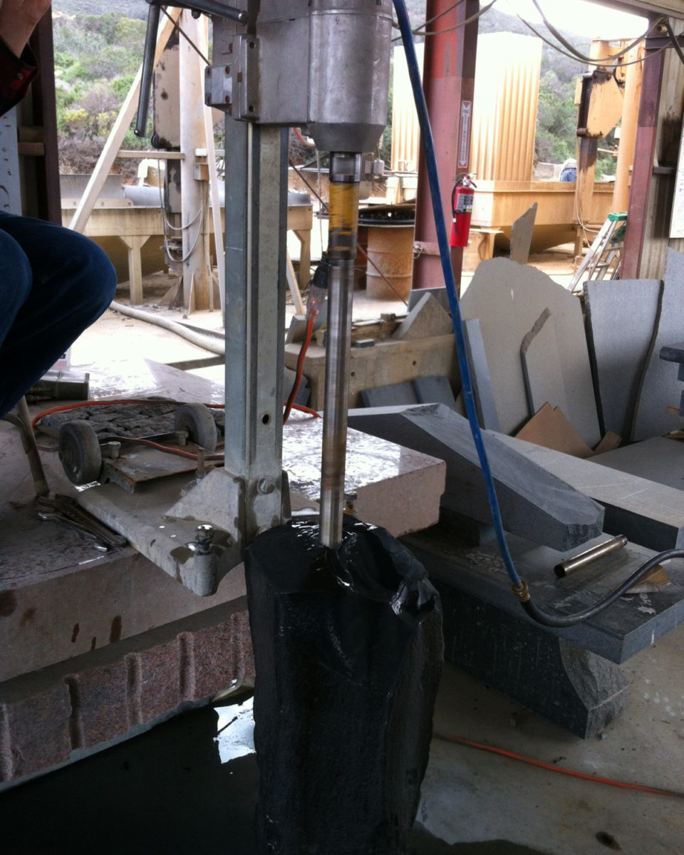 Black custom stone being drilled