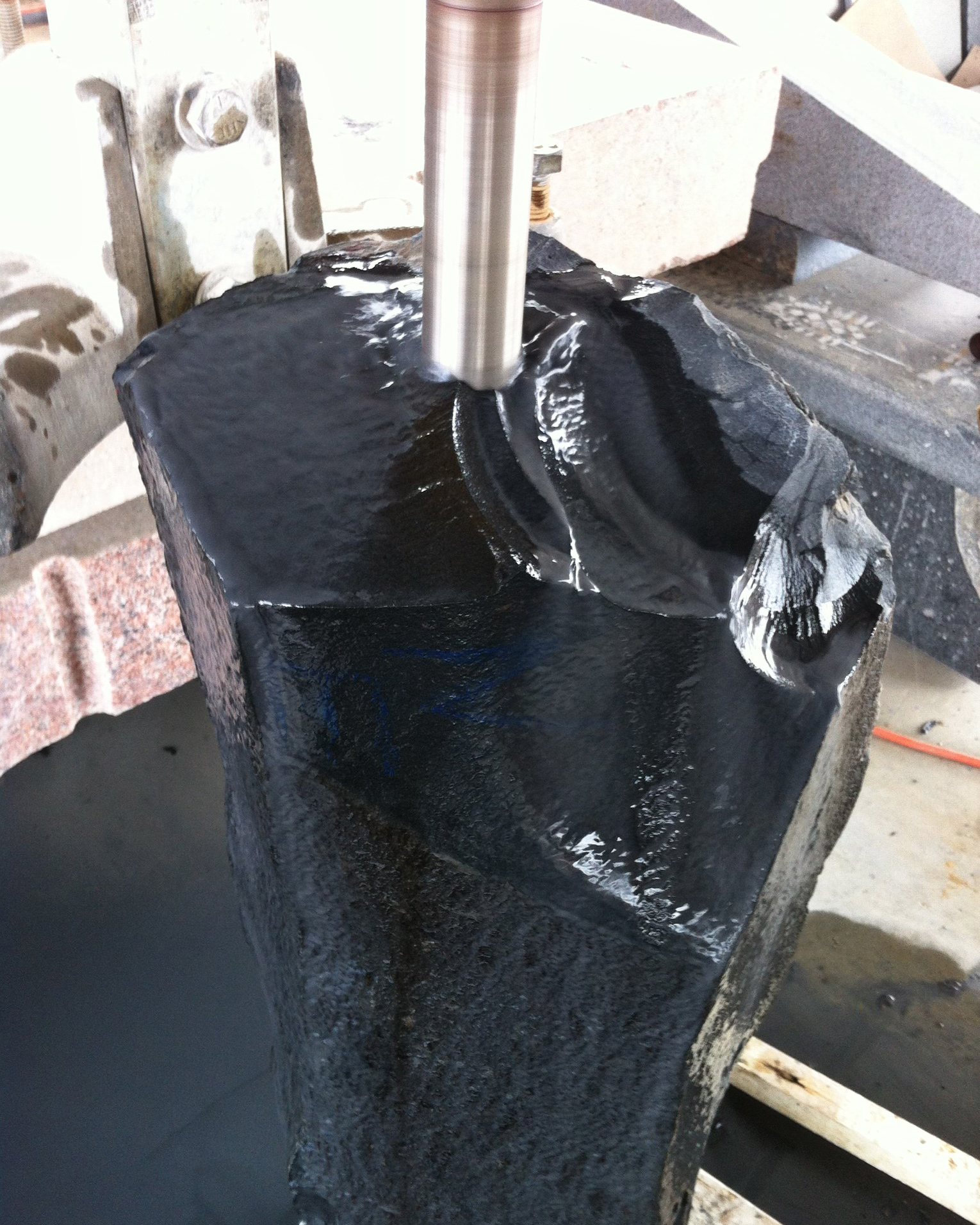 Black custom rock being drilled